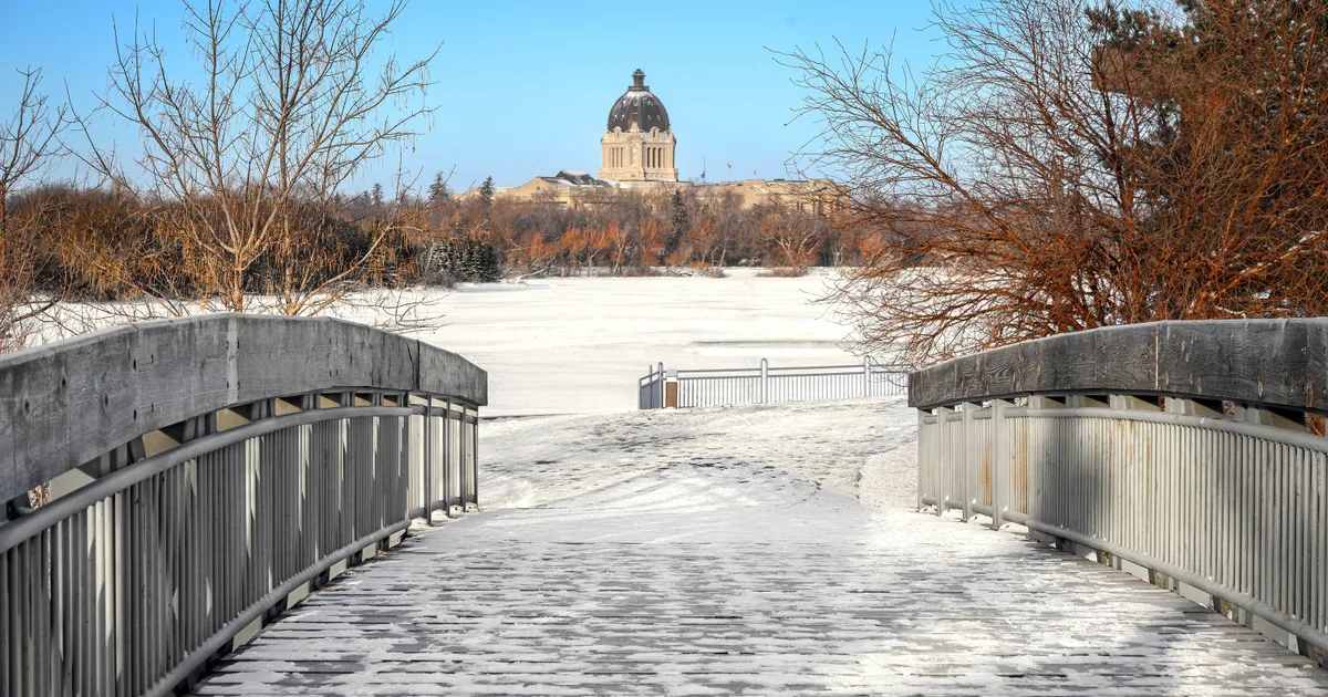 The Saskatchewan Legislative Building across frozen Wascana Lake in Regina, the city where loans Regina borrowers weigh a payday loan against an installment loan under Saskatchewan rules
